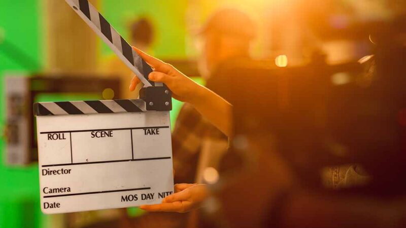 Close up Shot On Film Studio Set Young Camera Assistant Holds Em